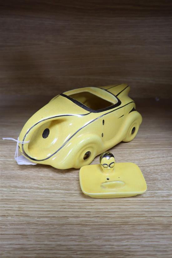 A Sadlers yellow glazed racing car teapot and cover, with silver lustre detail, registration OKT42